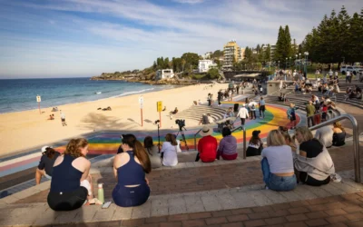 Woman mauled by shark off Sydney beach grabs onto a lifeguard’s paddleboard
