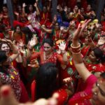 Women sing and dance at Pashupatinath Temple during the Teej festival in Kathmandu